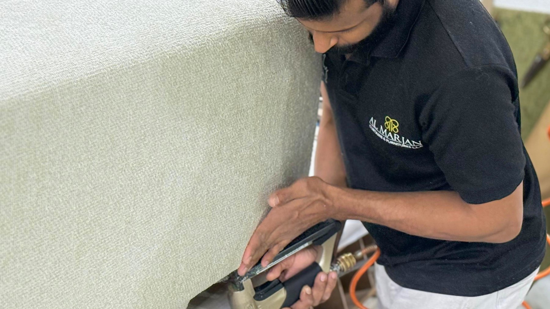 Al Marjan craftsman upholstering a bespoke piece