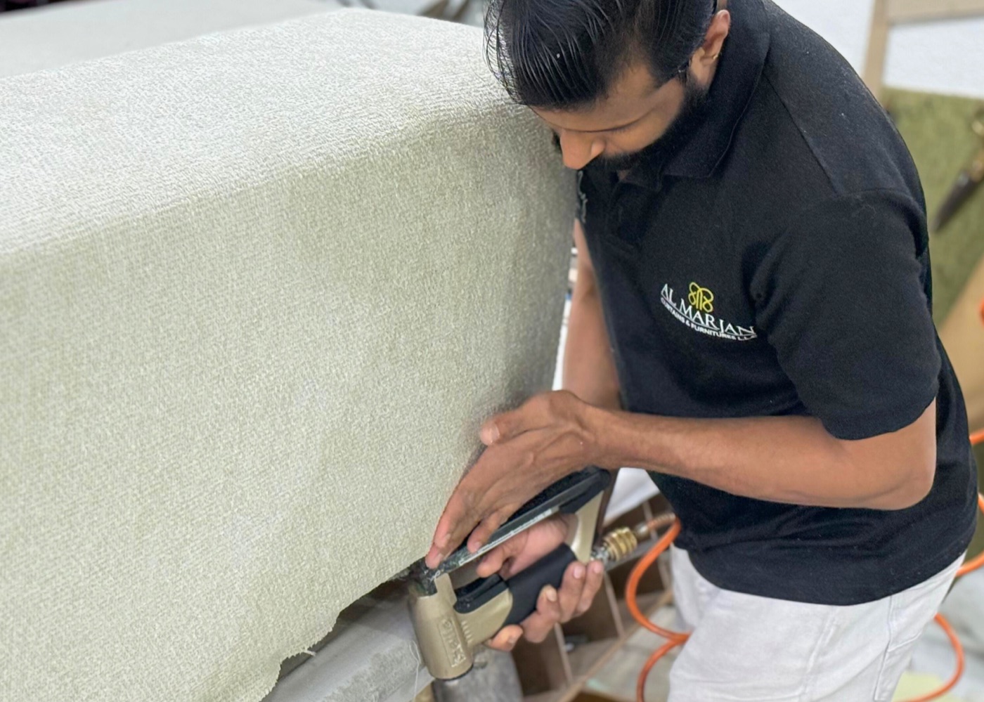 Al Marjan artisan stapling upholstery in the workshop